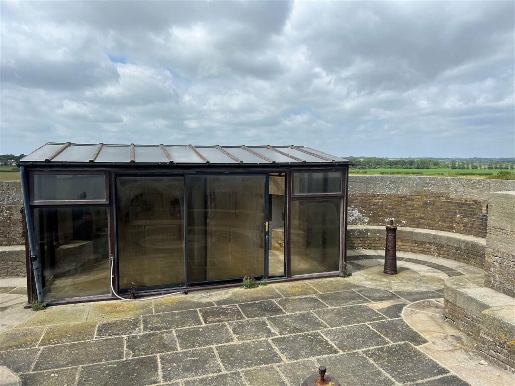 A 19th-century Martello tower in Suffolk, transformed into a quirky home with panoramic North Sea views, is for sale at £450,000. Features 3 bedrooms and a historic gun deck.