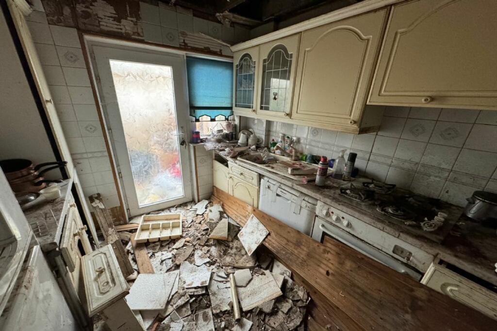 A £10,000 two-bedroom fixer-upper in Kirkintilloch, Scotland, needs major renovation. Ideal for DIY enthusiasts, it offers a conservatory, garden, and great location near shops and schools.