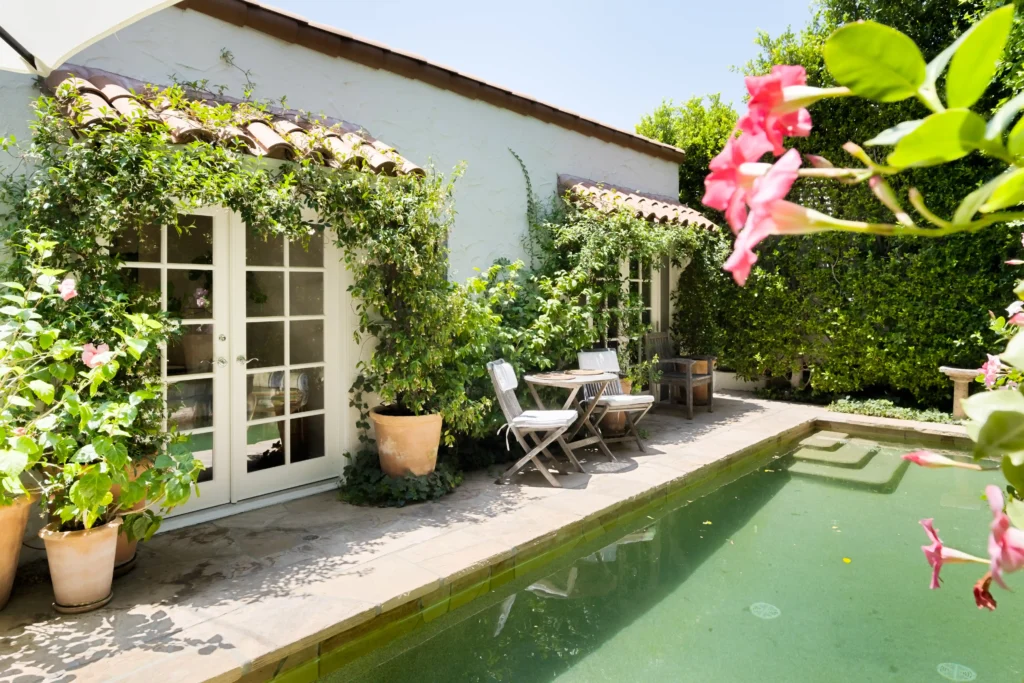 The storybook bungalow, once owned by Hollywood actor Robert Duvall, is for sale at $2M. This charming 1920s two-bed home in West Hollywood features a courtyard, pool, and lush gardens.