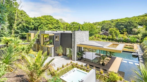 Luxury four-bedroom home near Perranporth, Cornwall, with a natural swimming pond, eco-friendly features, and modern Californian-inspired design on the market for £1.85 million.