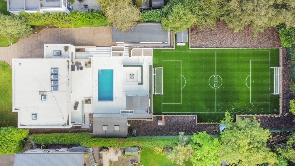 Tottenham's James Maddison lists £2.5M house with its own football pitch, outdoor pool, and bar featuring Premier League stars' shirts. Luxurious property boasts top security.