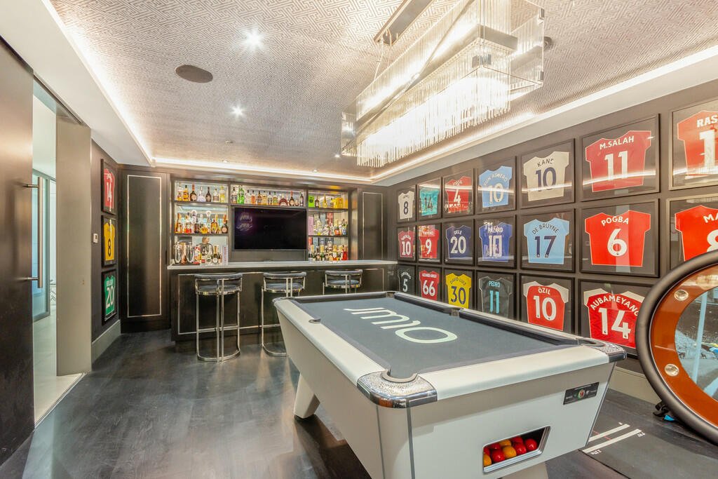 Tottenham's James Maddison lists £2.5M house with its own football pitch, outdoor pool, and bar featuring Premier League stars' shirts. Luxurious property boasts top security.