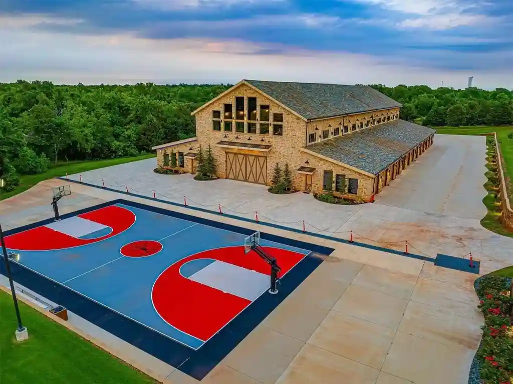 Luxury $17M mansion in Oklahoma City boasts 8 bedrooms, 16 bathrooms, dance floor, bar, bowling alley, sports courts, 70,000-gallon pool, and 36 acres of land. Ultimate entertainer's paradise.