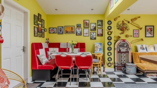 Quirky American-inspired home in York, featuring a replica 'Herbie' car, diner, and jukebox, is on sale for £585,000. Three-bedroom property boasts unique decor and modern amenities.