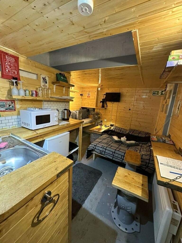 Cornwall 'bunker' listed for £45,000—perfect for the apocalypse. This unique micro-home, formerly a pumping station, offers quirky, industrial-themed living space.