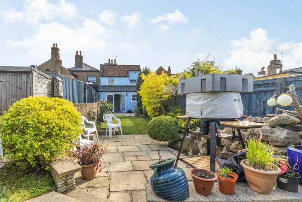 A charming cottage with a unique twist is on the market for £485,000, featuring a front door accessed through a bustling pub garden in Chenies Village, Herefordshire.