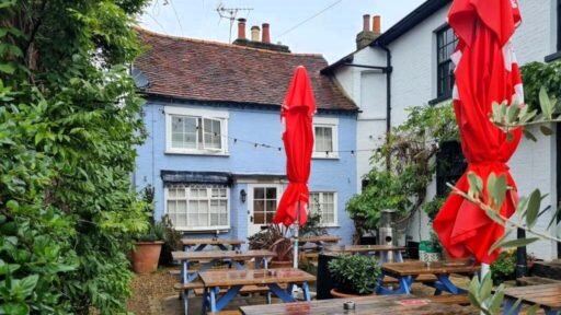 A charming cottage with a unique twist is on the market for £485,000, featuring a front door accessed through a bustling pub garden in Chenies Village, Herefordshire.