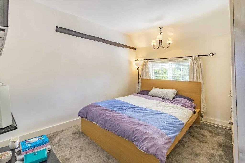 A charming cottage with a unique twist is on the market for £485,000, featuring a front door accessed through a bustling pub garden in Chenies Village, Herefordshire.