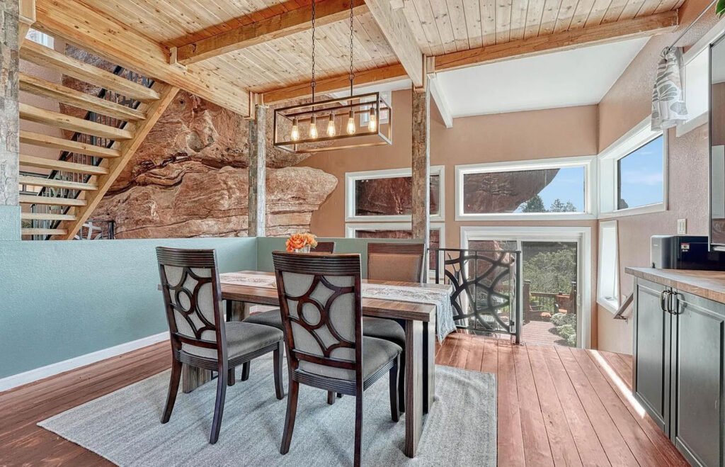 Explore the unique 'Rock House' in Larkspur, Colorado—built into a 200-million-year-old rock face, this 4-level home offers stunning natural views for just under $1M.