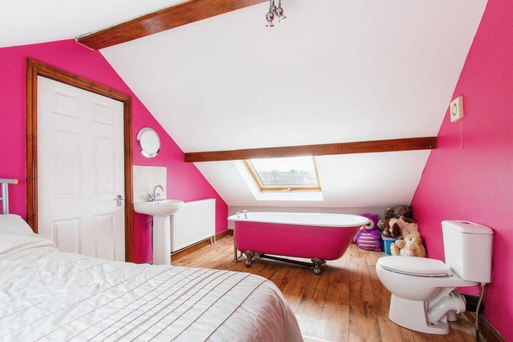 Quirky £360,000 bungalow in Leeds features a pink bedroom with a toilet just inches from the bed, sparking curiosity. A unique find with four bedrooms and open-plan living.