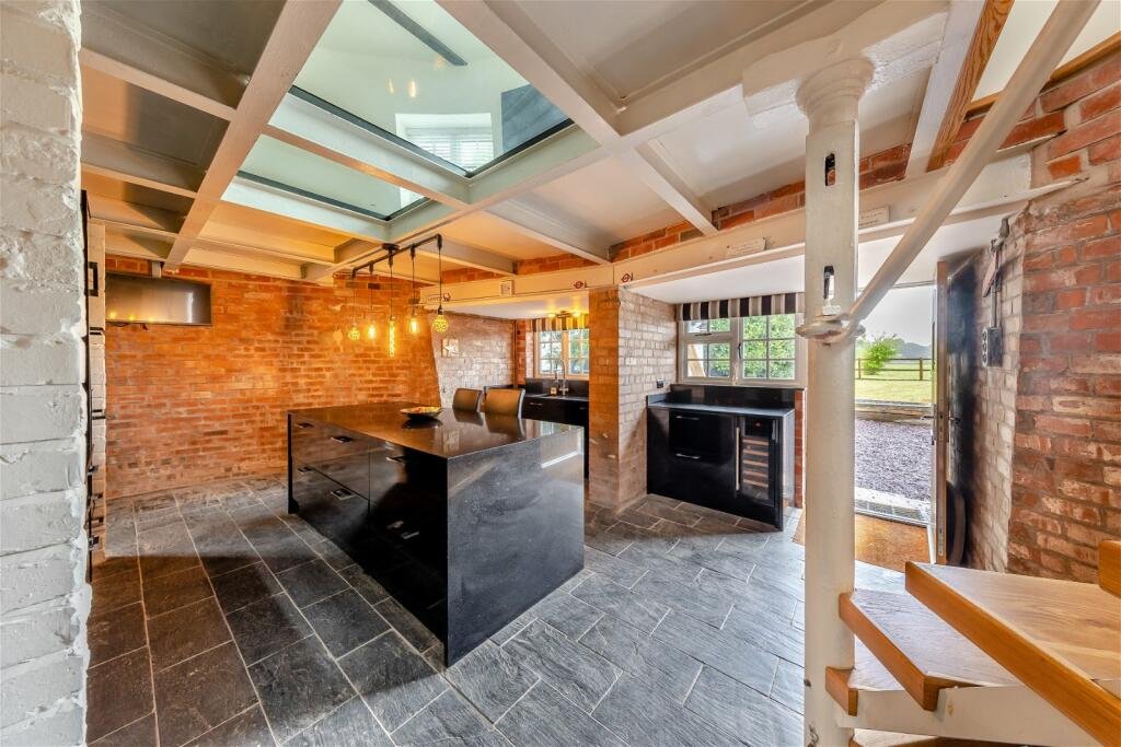 Historic 17th-century windmill converted into a modern family home with original features, 1.65 acres, and planning permission, now on the market near Chester for £850,000.