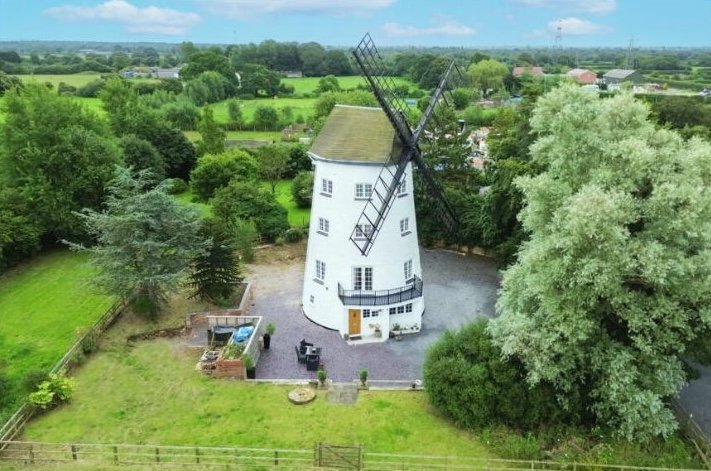 Historic 17th-century windmill converted into a modern family home with original features, 1.65 acres, and planning permission, now on the market near Chester for £850,000.