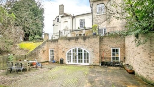 Discover a hidden gem in Suffolk: a Grade-II listed maisonette with stunning arches, priced at £135,000. Needs renovation due to flooding, but ideal for DIY enthusiasts.