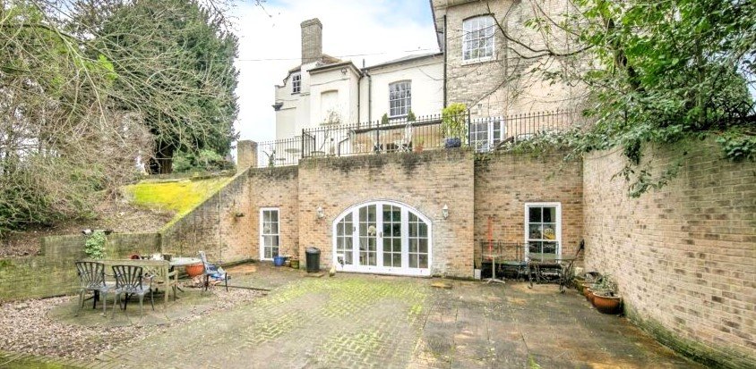 Discover a hidden gem in Suffolk: a Grade-II listed maisonette with stunning arches, priced at £135,000. Needs renovation due to flooding, but ideal for DIY enthusiasts.