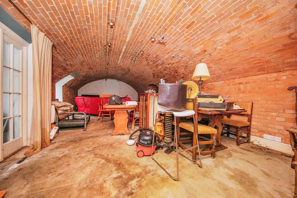 Discover a hidden gem in Suffolk: a Grade-II listed maisonette with stunning arches, priced at £135,000. Needs renovation due to flooding, but ideal for DIY enthusiasts.