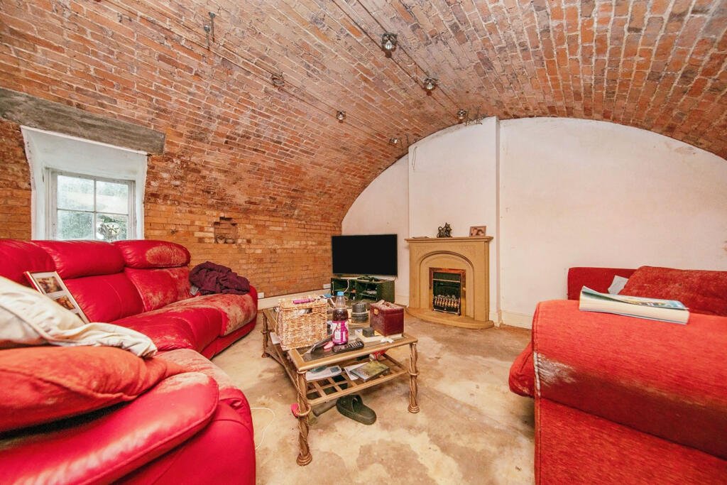 Discover a hidden gem in Suffolk: a Grade-II listed maisonette with stunning arches, priced at £135,000. Needs renovation due to flooding, but ideal for DIY enthusiasts.