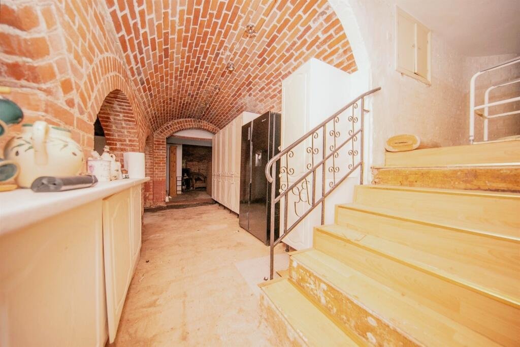 Discover a hidden gem in Suffolk: a Grade-II listed maisonette with stunning arches, priced at £135,000. Needs renovation due to flooding, but ideal for DIY enthusiasts.