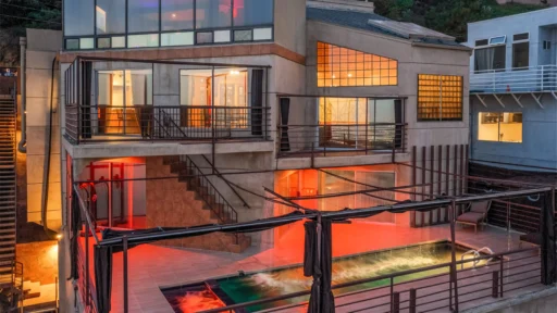 A "mini Playboy mansion" in LA, owned by photographer Richard Franklin, is on the market for $10M. Features include a nightclub, stripper pole, rooftop cabana, and stunning city views.