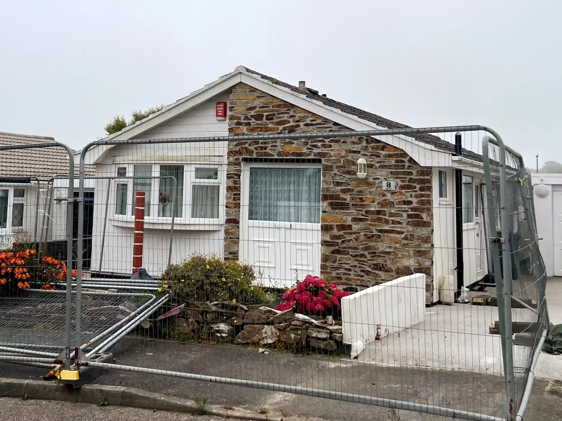 A Cornwall home with a gaping mineshaft hole is being auctioned for £35,000. Despite exterior damage, the four-bedroom property in Carbis Bay offers spacious interiors and potential.