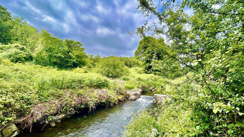 Own a stunning Grade II Listed 5-bedroom home with hidden mill in scenic Middle Mill, Wales, for £700,000. Includes a separate apartment, original features, and riverside gardens.