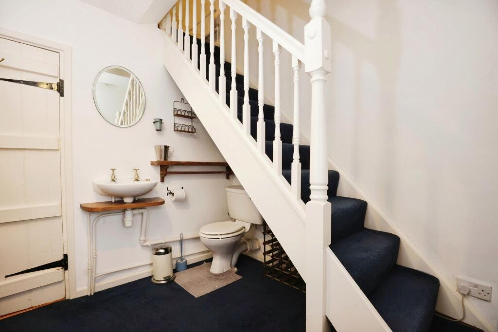 Quirky detached house near Stratford-upon-Avon for sale at £175,000, featuring two bedrooms, a garden, and a unique toilet under the stairs. Auction ends soon!