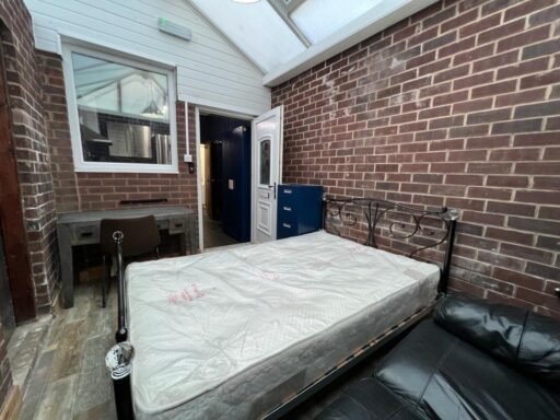 Viral outrage over a £1,200/month Manchester "studio" in a conservatory sparks backlash, as social media users criticize the small, glass-roofed space for rent.