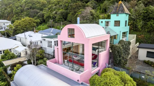 A stunning all-pink home, reminiscent of a Barbie dreamhouse, is on the market in Thorndon, New Zealand, for $1,895,000 NZD. This whimsical 4-level, 3-bedroom home offers breathtaking city and harbour views.