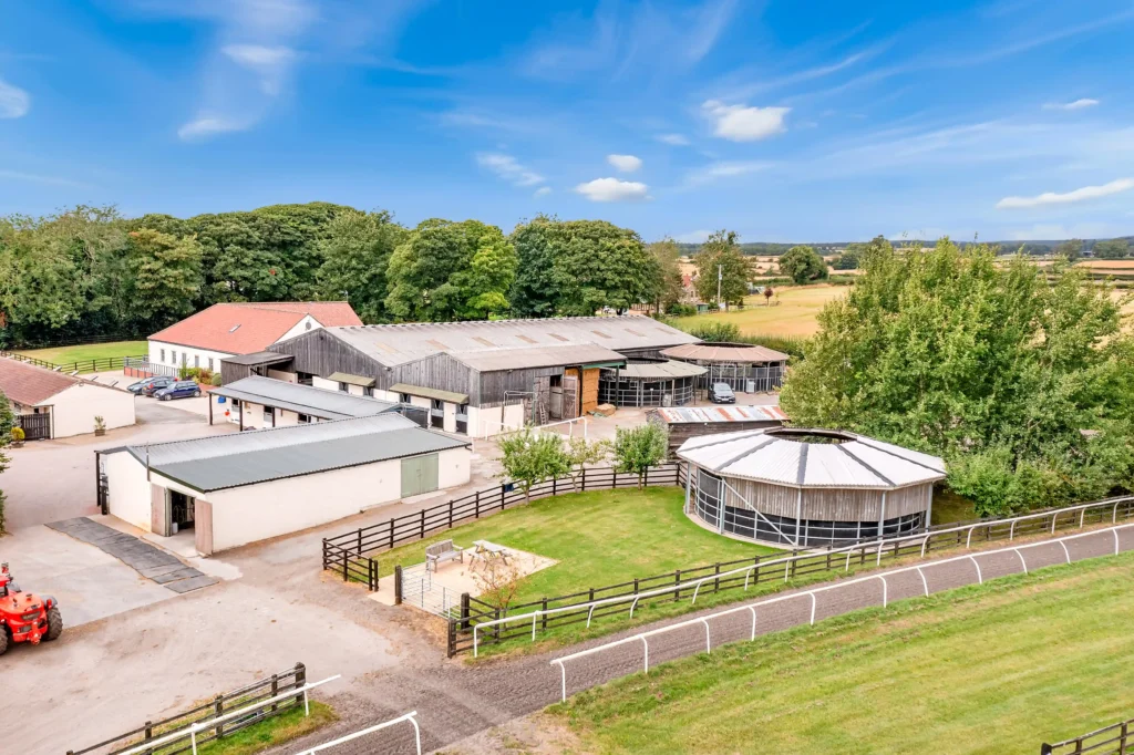 Discover Arthington Barn Stables—a 23-acre equestrian haven in North Yorkshire with 55 stables, gallops, a 3-bedroom house, and development potential. On the market now.