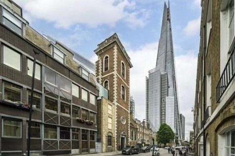 Historic London flat inside a converted church is available for rent at £4,000 per month, featuring five storeys, modern design, and stunning city views.