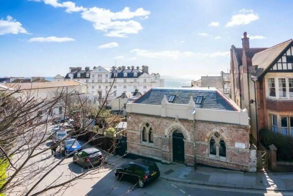 Victorian bathhouse turned quirky family home hits the market for £1.1M, featuring circus-themed décor, a bowling alley, cinema room, and sun terrace in East Sussex.