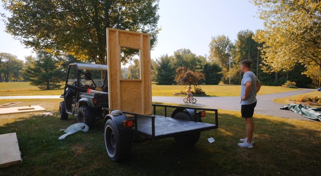 A man builds what he claims to be the world's smallest tiny home at 19.46 sq ft, complete with a bed, kitchen, and toilet, aiming for a Guinness World Record.