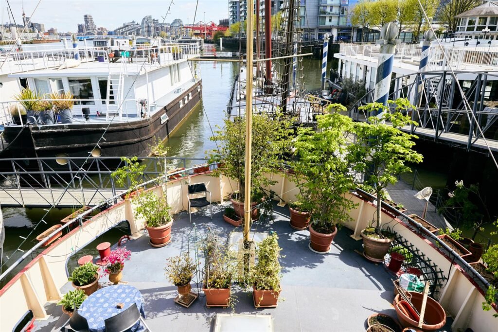 Luxury 5-bedroom houseboat with fireplace, 3 open decks, and stunning Thames views hits the market in London for £1.8m. Moored at Prospect Quay, it's a unique riverside gem.