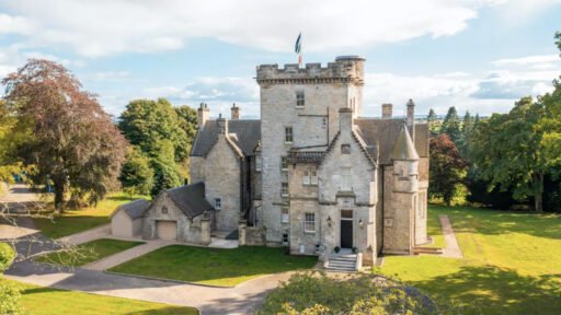 A breathtaking 1864 Scottish castle near Edinburgh, featuring eight bedrooms, modern interiors, a library, and a Biomass heating system, is on sale for £3.95M via Strutt & Parker.