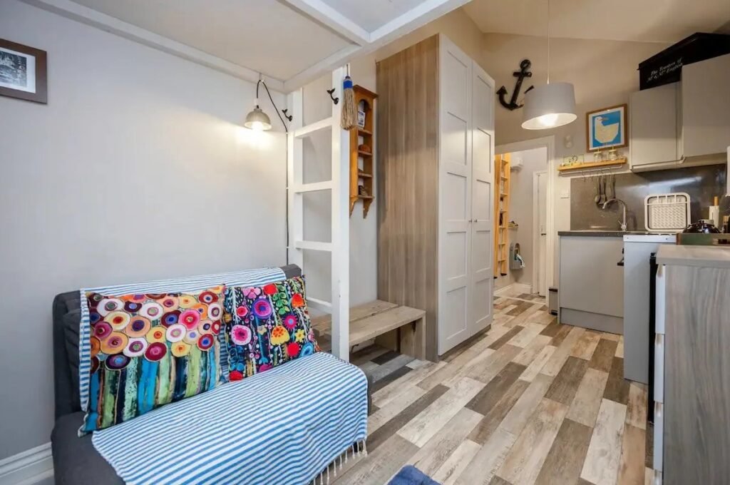 Brighton studio flat likened to a "cupboard" hits the market for £160,000. Tiny mezzanine bed area and open-plan kitchen just seconds from the sea spark reactions.