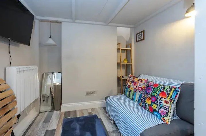 Brighton studio flat likened to a "cupboard" hits the market for £160,000. Tiny mezzanine bed area and open-plan kitchen just seconds from the sea spark reactions.