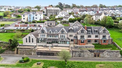 A stunning 27-bedroom former nunnery with sea views in Fishguard, South Wales, is on the market for £750,000. The property includes a chapel, cottages, and panoramic harbor views.