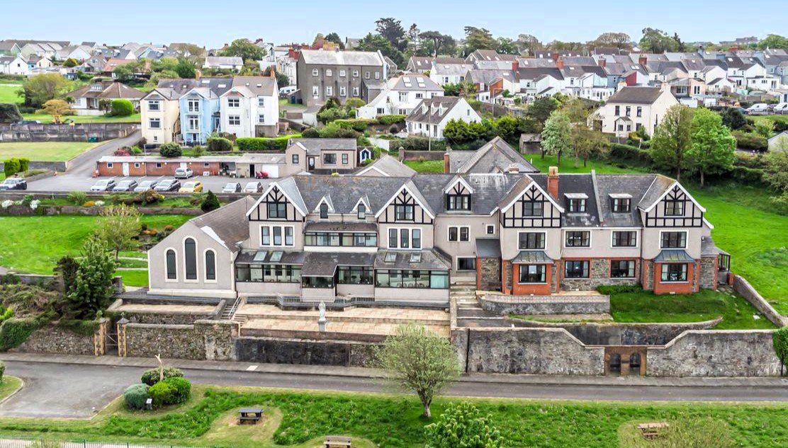 A stunning 27-bedroom former nunnery with sea views in Fishguard, South Wales, is on the market for £750,000. The property includes a chapel, cottages, and panoramic harbor views.