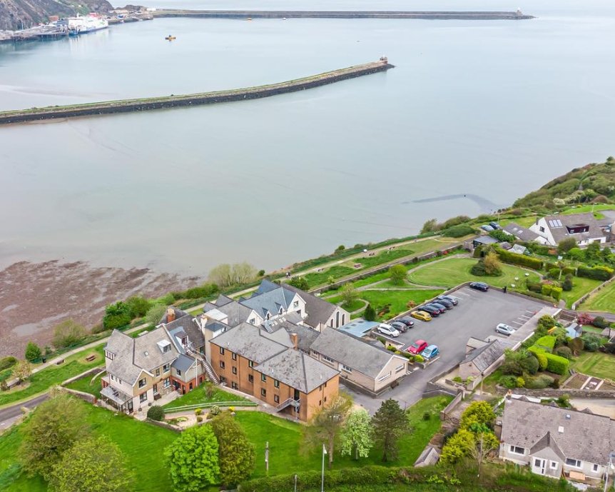 A stunning 27-bedroom former nunnery with sea views in Fishguard, South Wales, is on the market for £750,000. The property includes a chapel, cottages, and panoramic harbor views.