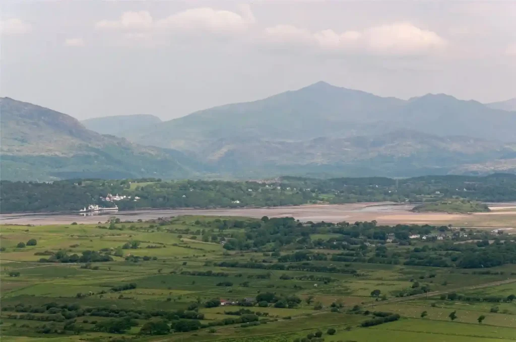 A stunning four-bedroom farmhouse with panoramic views of Snowdonia's Moelwynion mountains and the Llyn Peninsula is for sale at £775,000, offering rural bliss in Wales.