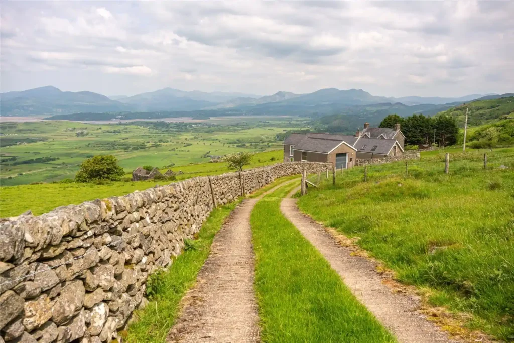 A stunning four-bedroom farmhouse with panoramic views of Snowdonia's Moelwynion mountains and the Llyn Peninsula is for sale at £775,000, offering rural bliss in Wales.