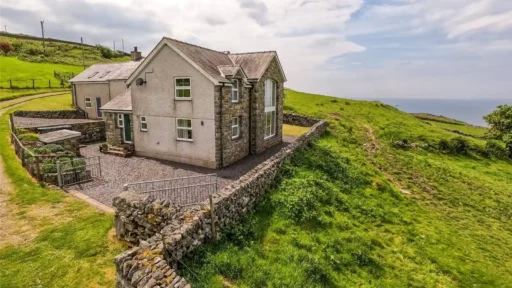 A stunning four-bedroom farmhouse with panoramic views of Snowdonia's Moelwynion mountains and the Llyn Peninsula is for sale at £775,000, offering rural bliss in Wales.