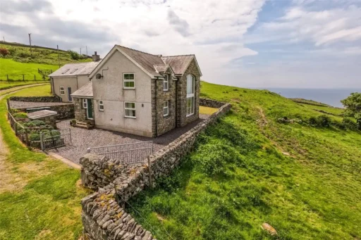 A stunning four-bedroom farmhouse with panoramic views of Snowdonia's Moelwynion mountains and the Llyn Peninsula is for sale at £775,000, offering rural bliss in Wales.