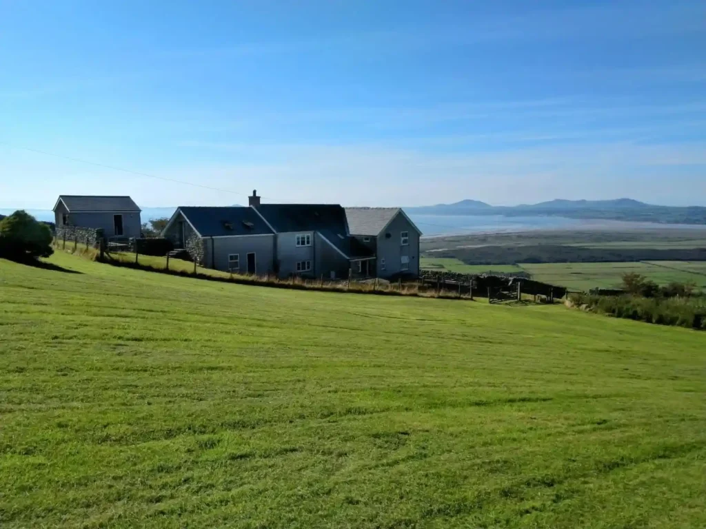 A stunning four-bedroom farmhouse with panoramic views of Snowdonia's Moelwynion mountains and the Llyn Peninsula is for sale at £775,000, offering rural bliss in Wales.