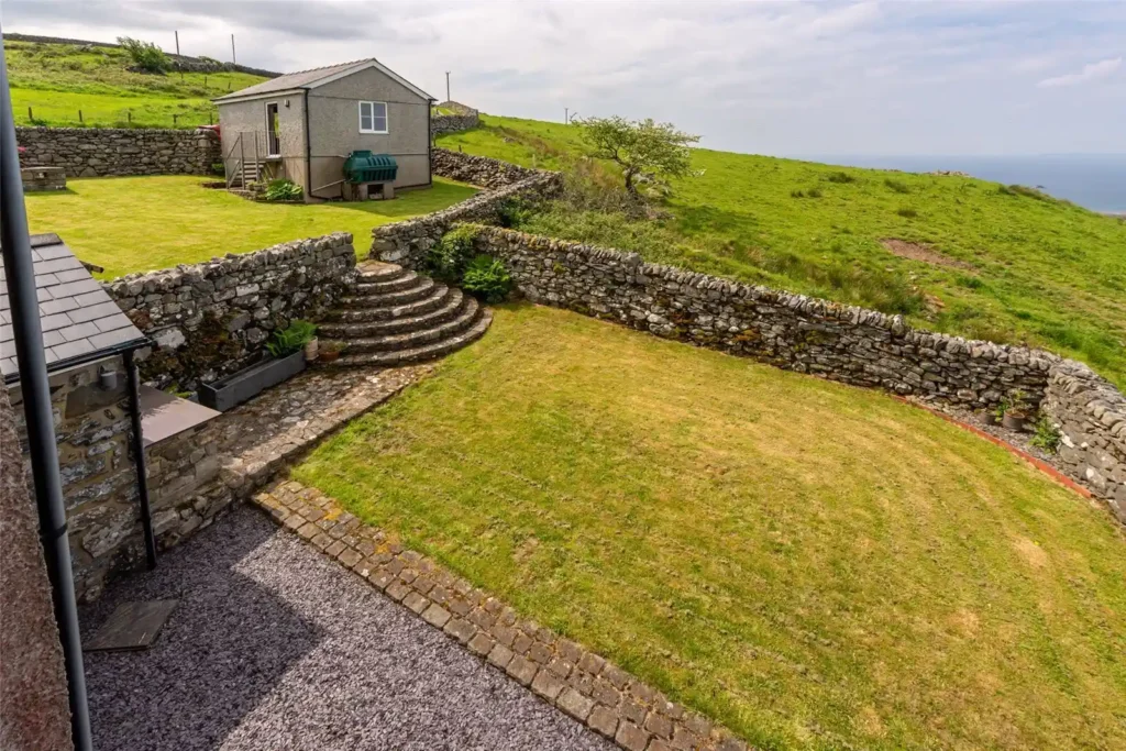 A stunning four-bedroom farmhouse with panoramic views of Snowdonia's Moelwynion mountains and the Llyn Peninsula is for sale at £775,000, offering rural bliss in Wales.