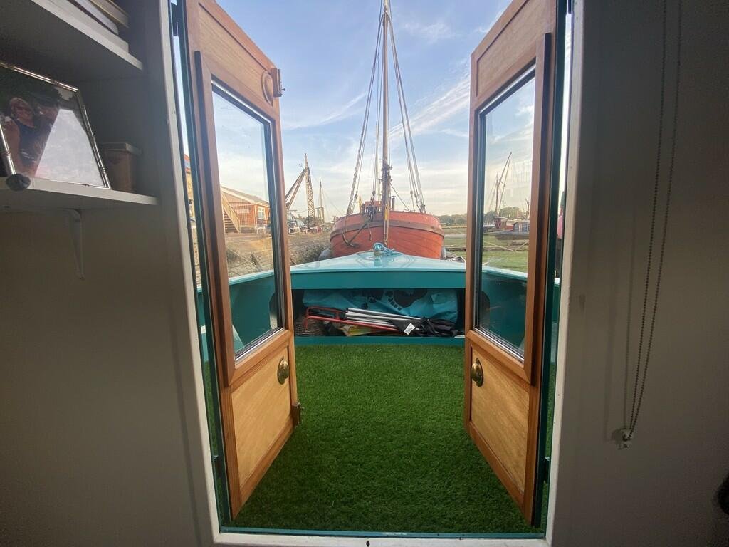 Escape the January blues in Woodbridge, Britain’s happiest place to live, with a charming two-bedroom houseboat, Ray of Sunshine, for just £119,000—tranquility included!