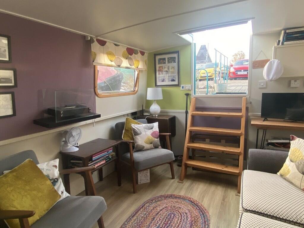 Escape the January blues in Woodbridge, Britain’s happiest place to live, with a charming two-bedroom houseboat, Ray of Sunshine, for just £119,000—tranquility included!