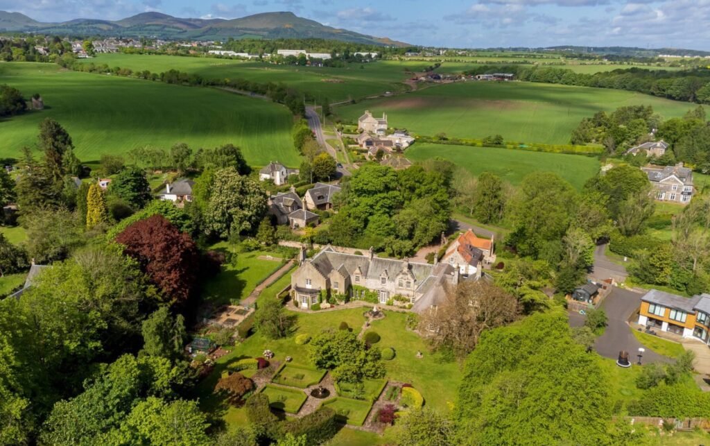 Explore Barony House, Sir Walter Scott's historic home near Edinburgh, now on sale for £1.8M. This six-bed mansion boasts rich literary history and 4.5 acres of gardens.