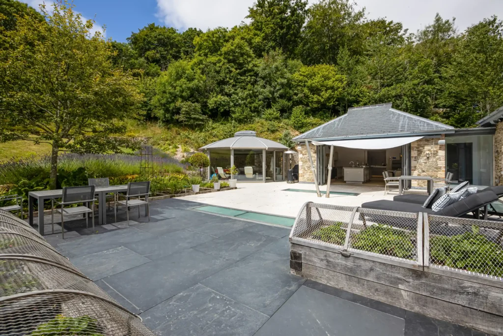 Explore Rectory Barn, a £4.5M luxury Salcombe home featuring a secret wine cellar, stunning estuary views, 1.56 acres, 4 bedrooms, and a hydro pool gym. Coastal elegance!