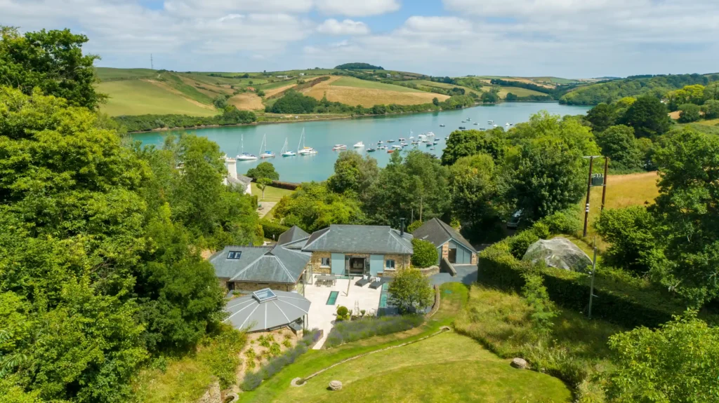 Explore Rectory Barn, a £4.5M luxury Salcombe home featuring a secret wine cellar, stunning estuary views, 1.56 acres, 4 bedrooms, and a hydro pool gym. Coastal elegance!