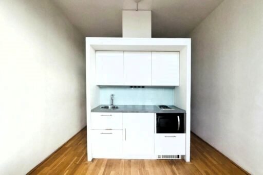 A £105,000 flat near Salford Quays with a bizarre kitchen-in-the-middle layout is dividing opinion online. Dubbed a "space prison," would you call it home?